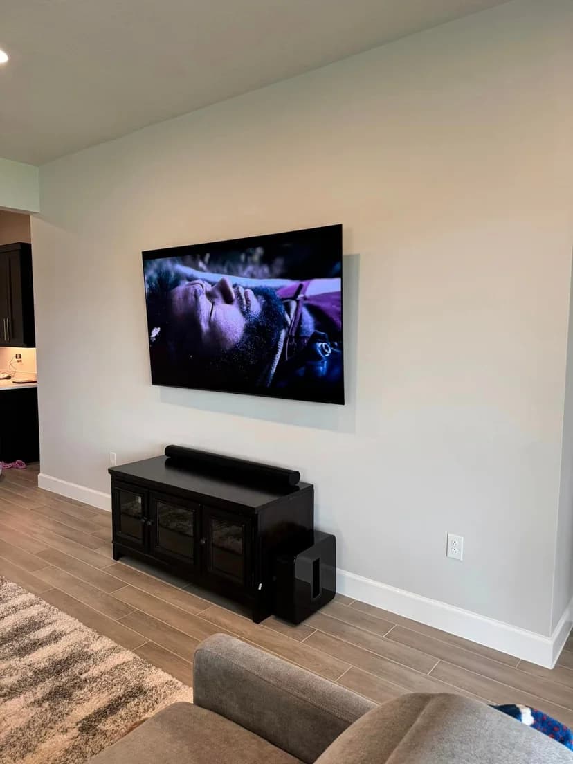 Soundbar and surround sound installation below wall-mounted TV